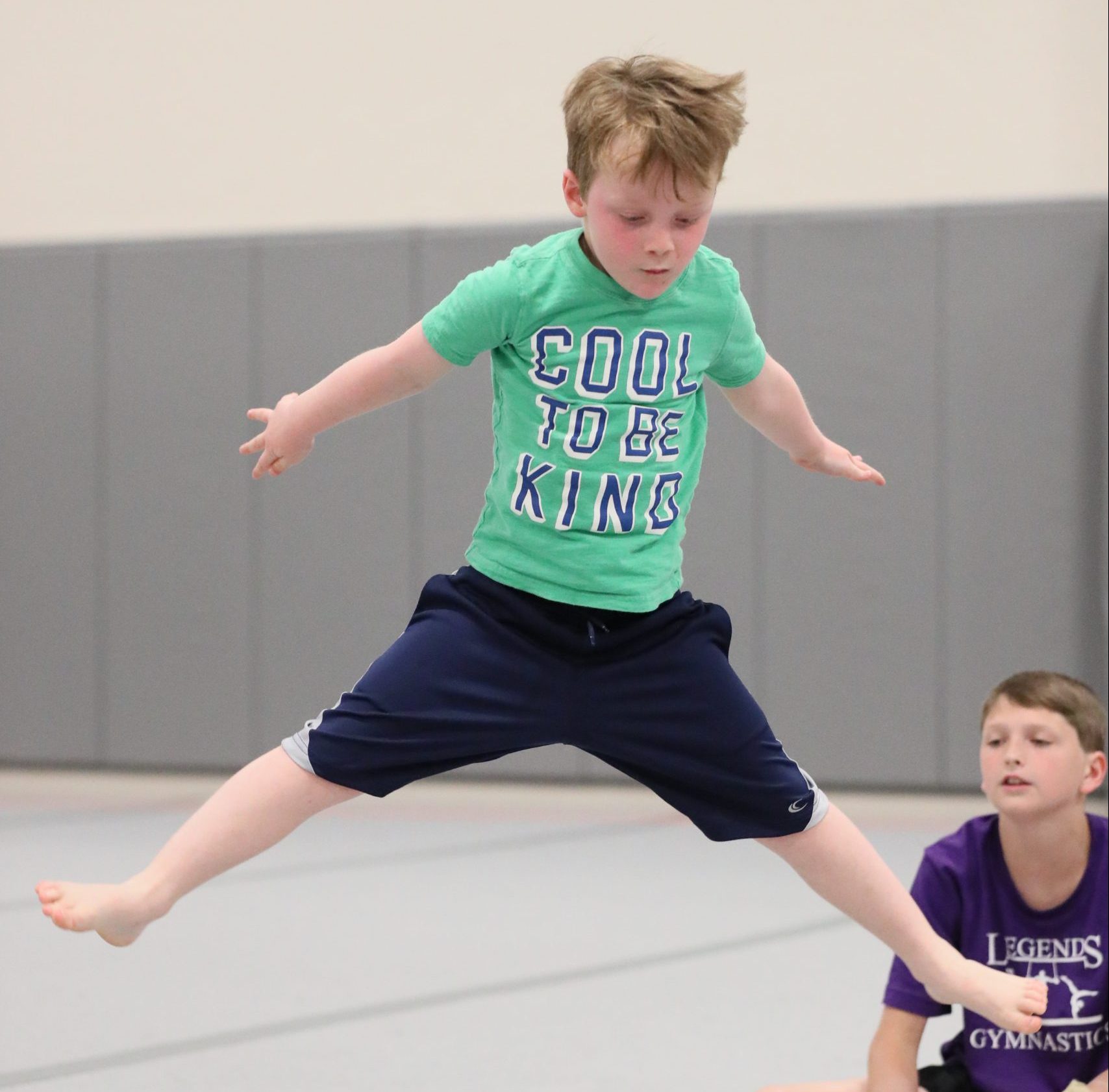 Kid doing a jumping split at Legends Gymnastics in North Andover, MA.
