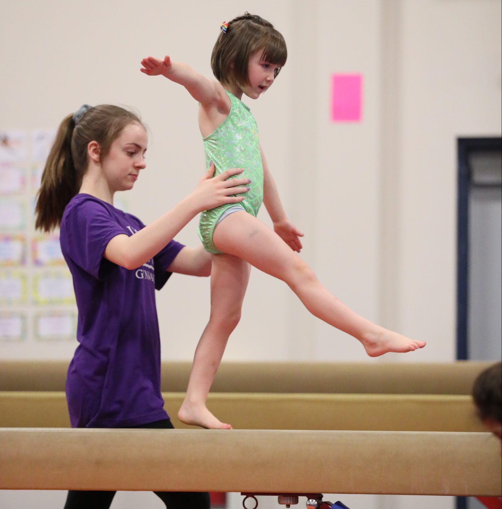 Little girl on beam at Legends Gymnastics in North Andover, MA.