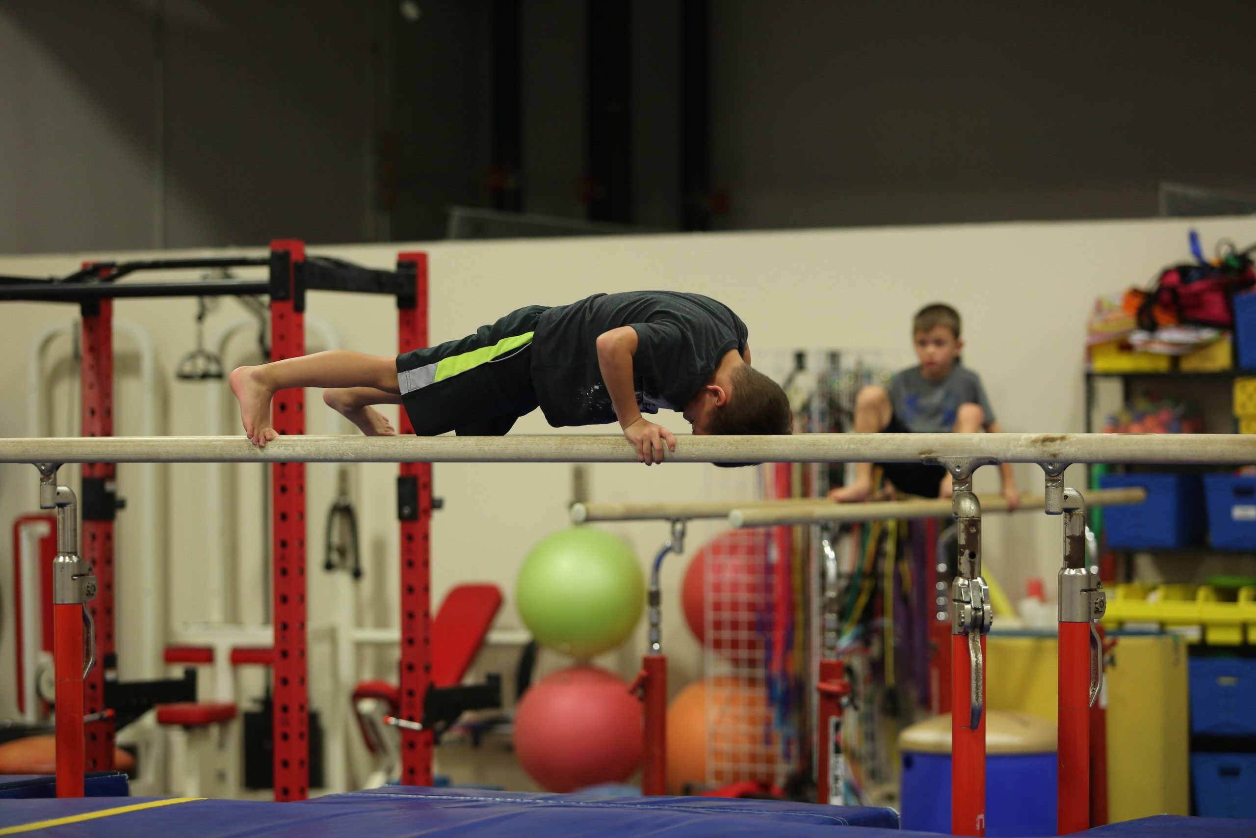 Boy on parallel bars at Legends Gymnastics in North Andover, MA.